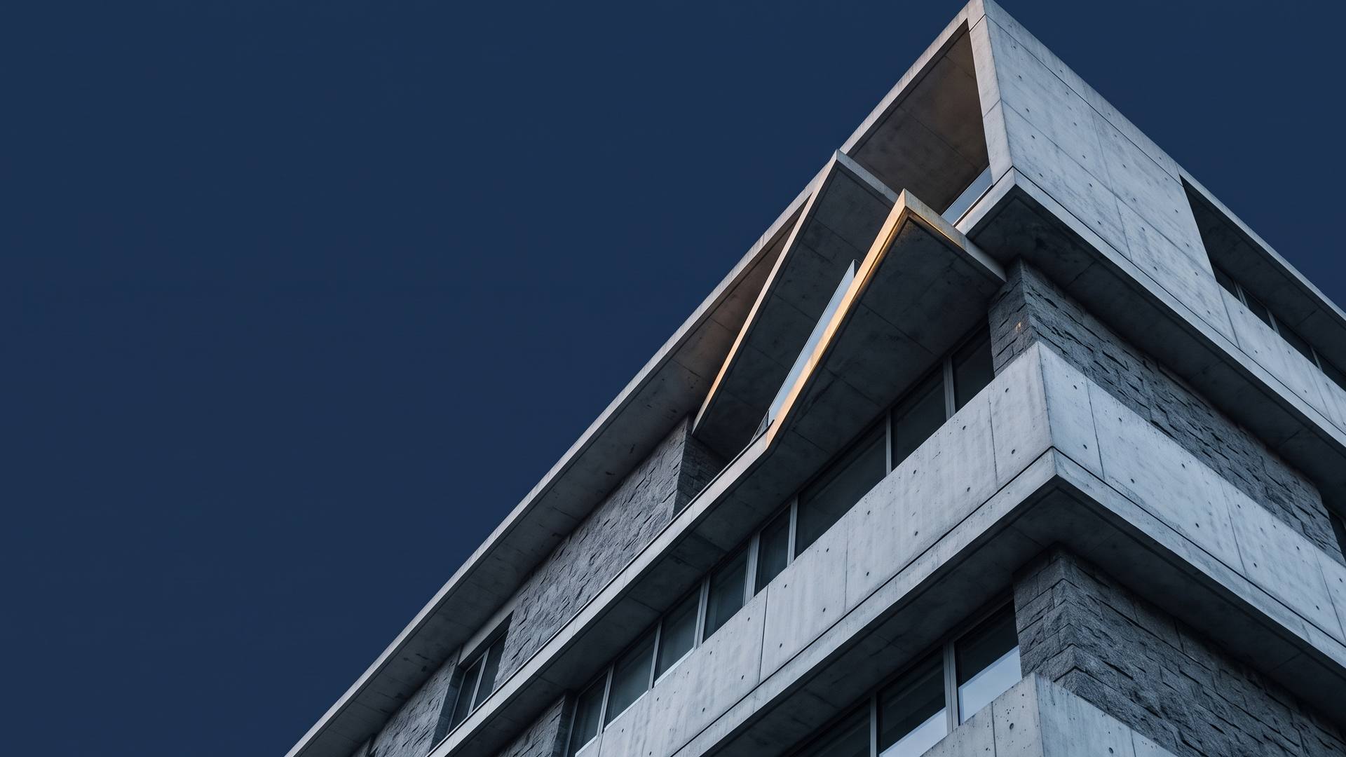 Concept visualisation of a concrete building corner seen from below against a night sky.