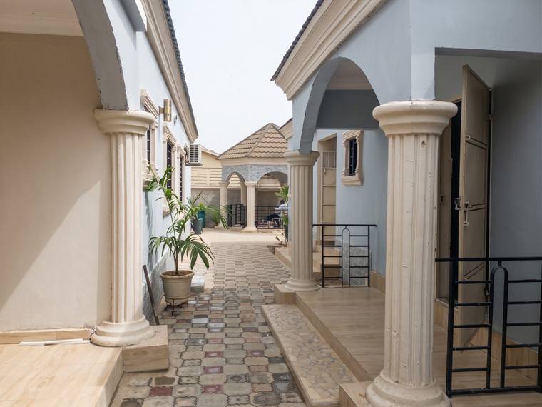 The paved central courtyard the plan wraps around, enclosed by the arcaded elevations of the house.