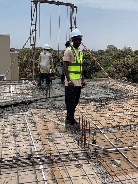 Seigh Nyass, Head Architect, photographed on site during construction.